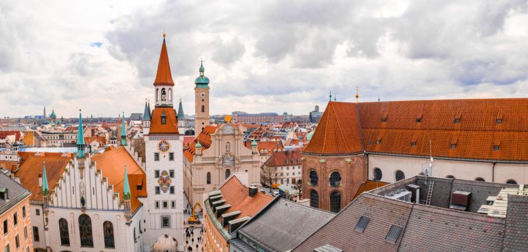 old town hall surrounded by buildings cloudy sky daytime munich germany